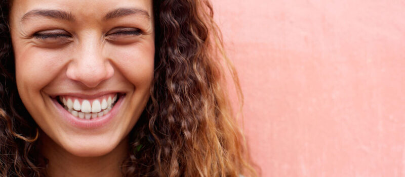 smiling woman peach background