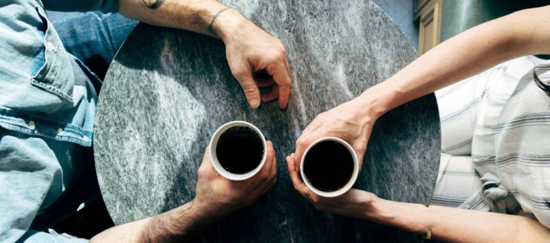 cups and hands on table